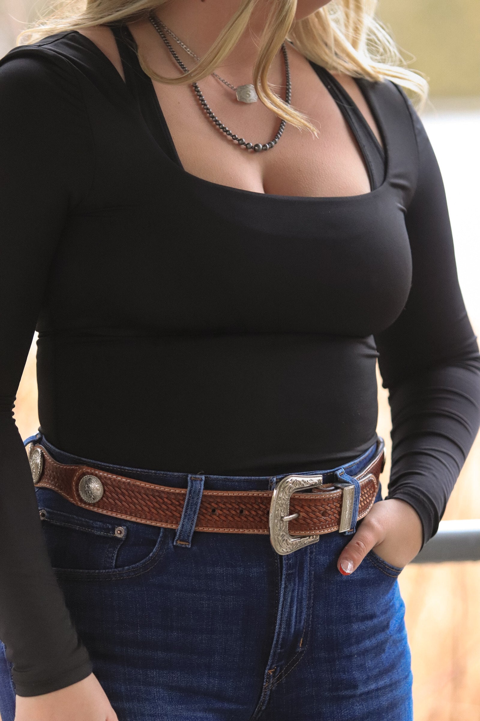 Side view of Saddle Ridge brown western leather belt with engraved buckle