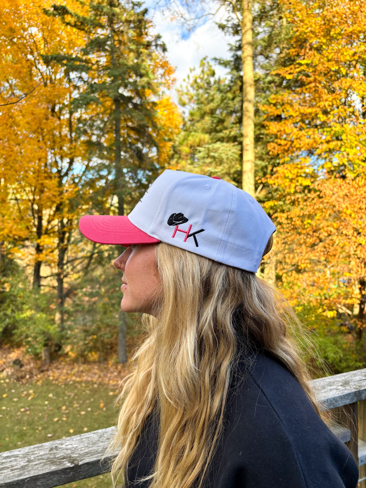 Back view of The Stampede Snapback in pink and white with Wild N Free embroidery above snapback closure.