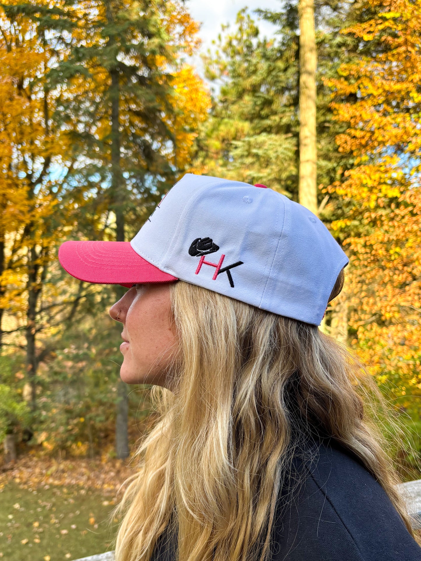 Back view of The Stampede Snapback in pink and white with Wild N Free embroidery above snapback closure.