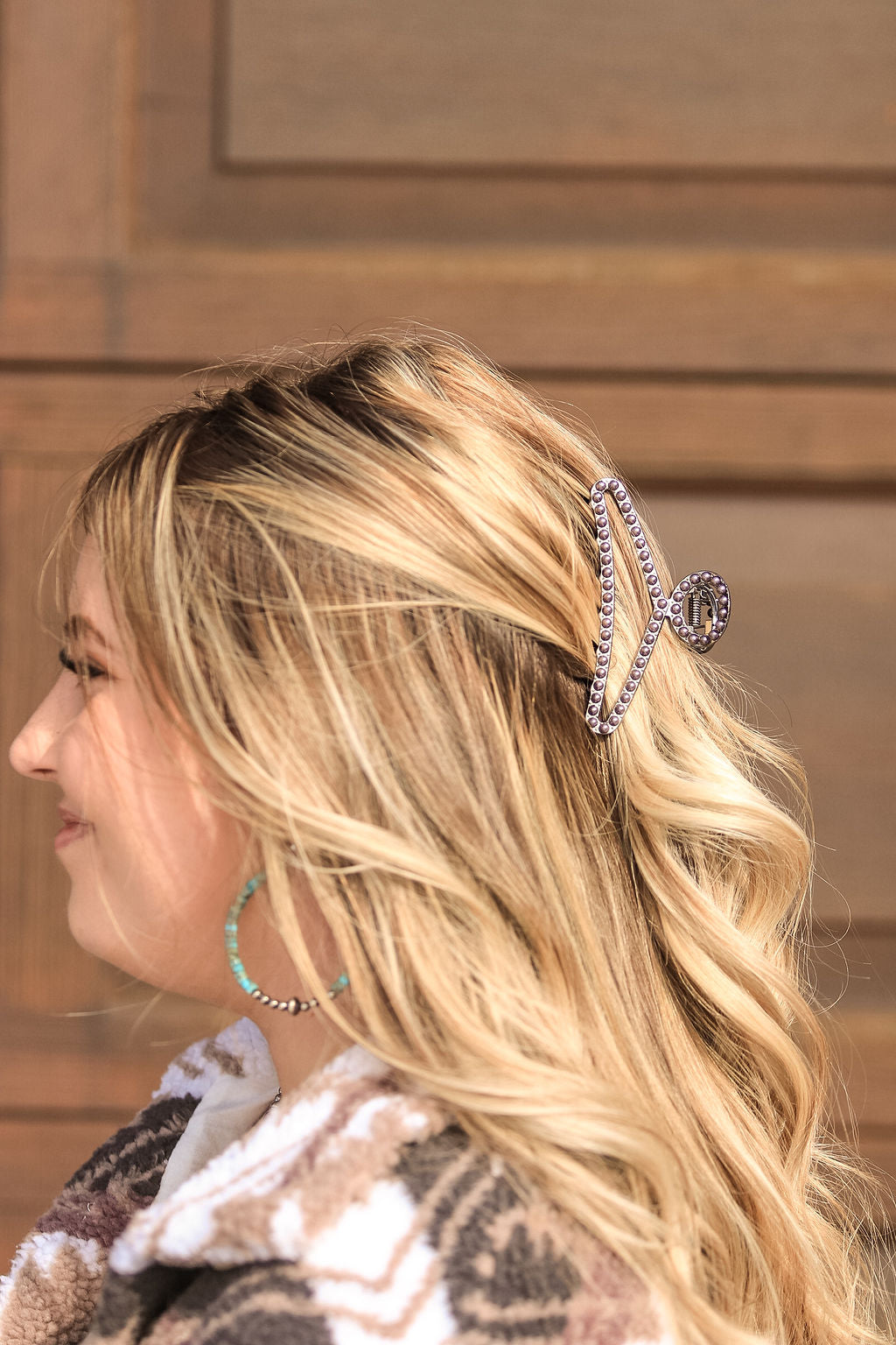 Side view of Midnight Pearl Claw Clip with deep pearl accents in sunlight