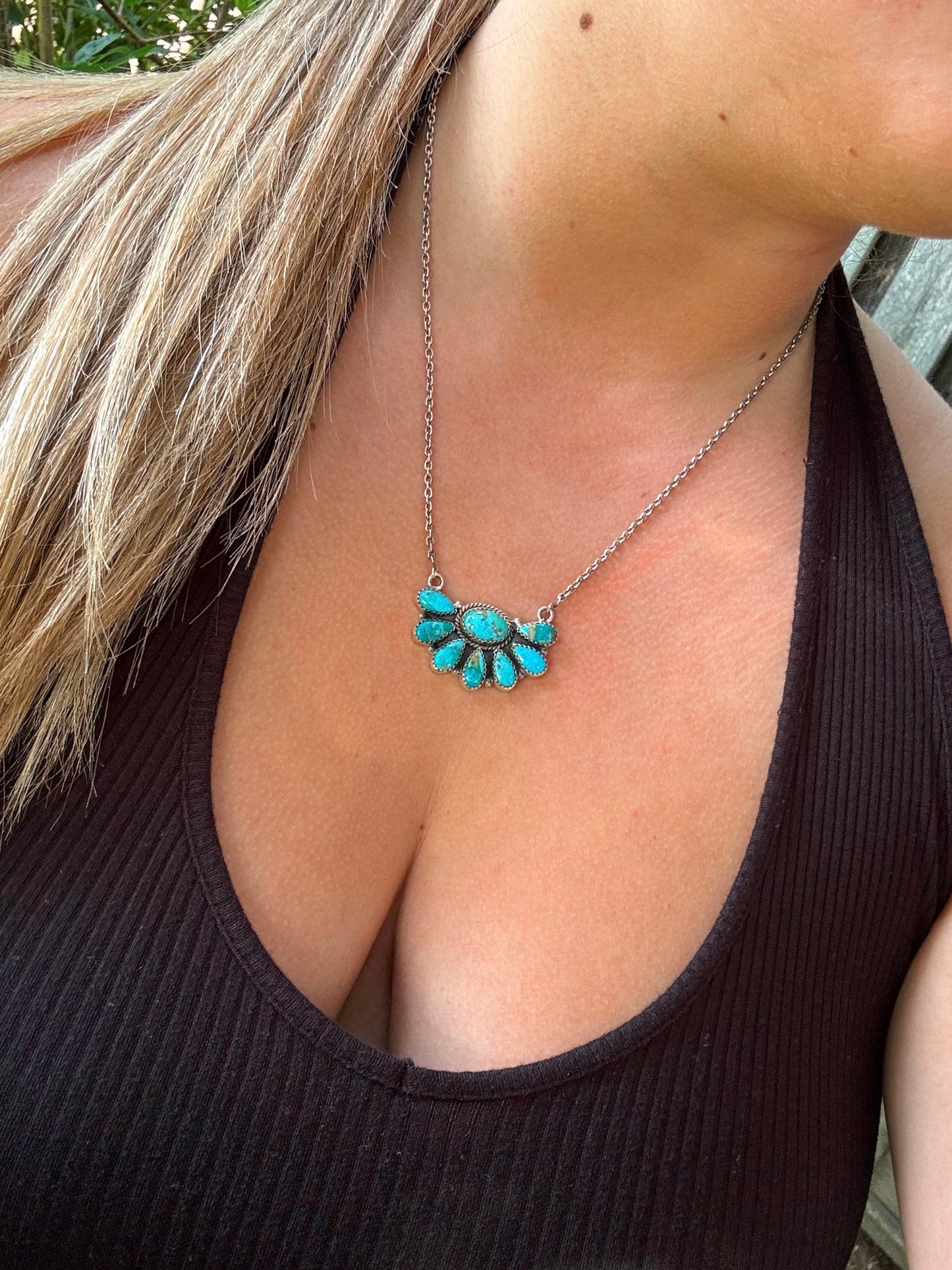 Close up of the Bluebell Cluster Necklace featuring genuine turquoise stones and a sterling silver setting.