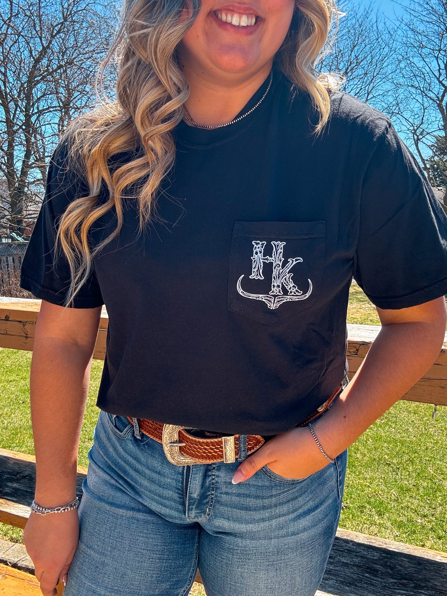 Full view of black branded pocket tee with longhorn graphic logo on front pocket
