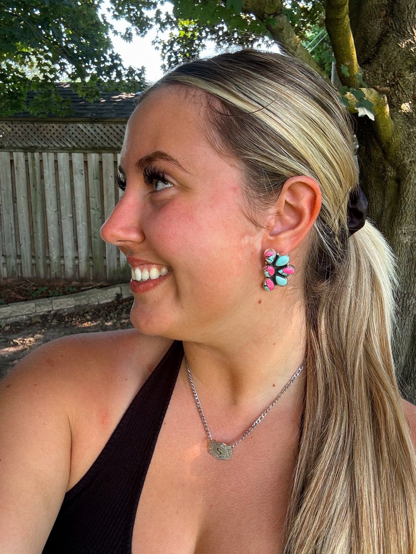 Woman smiling while wearing Cotton Candy Cluster Studs with vibrant pink and blue turquoise