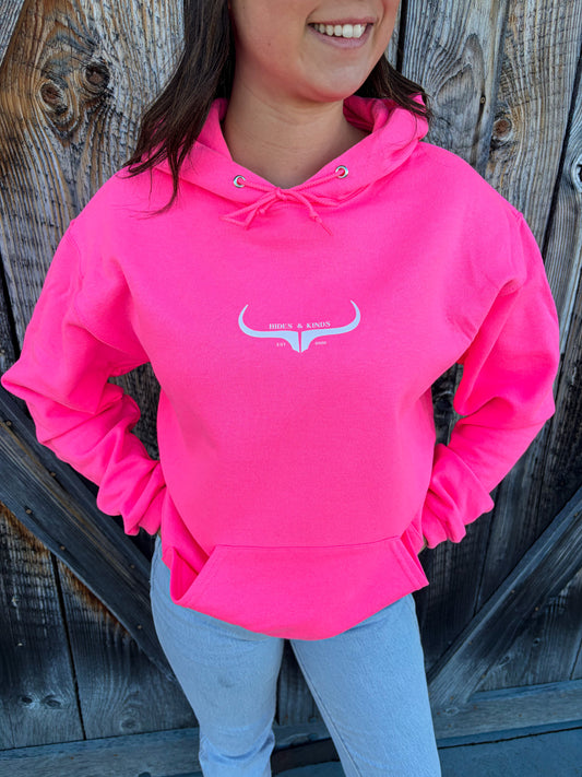 Bright pink country hoodie styled with denim and black hat