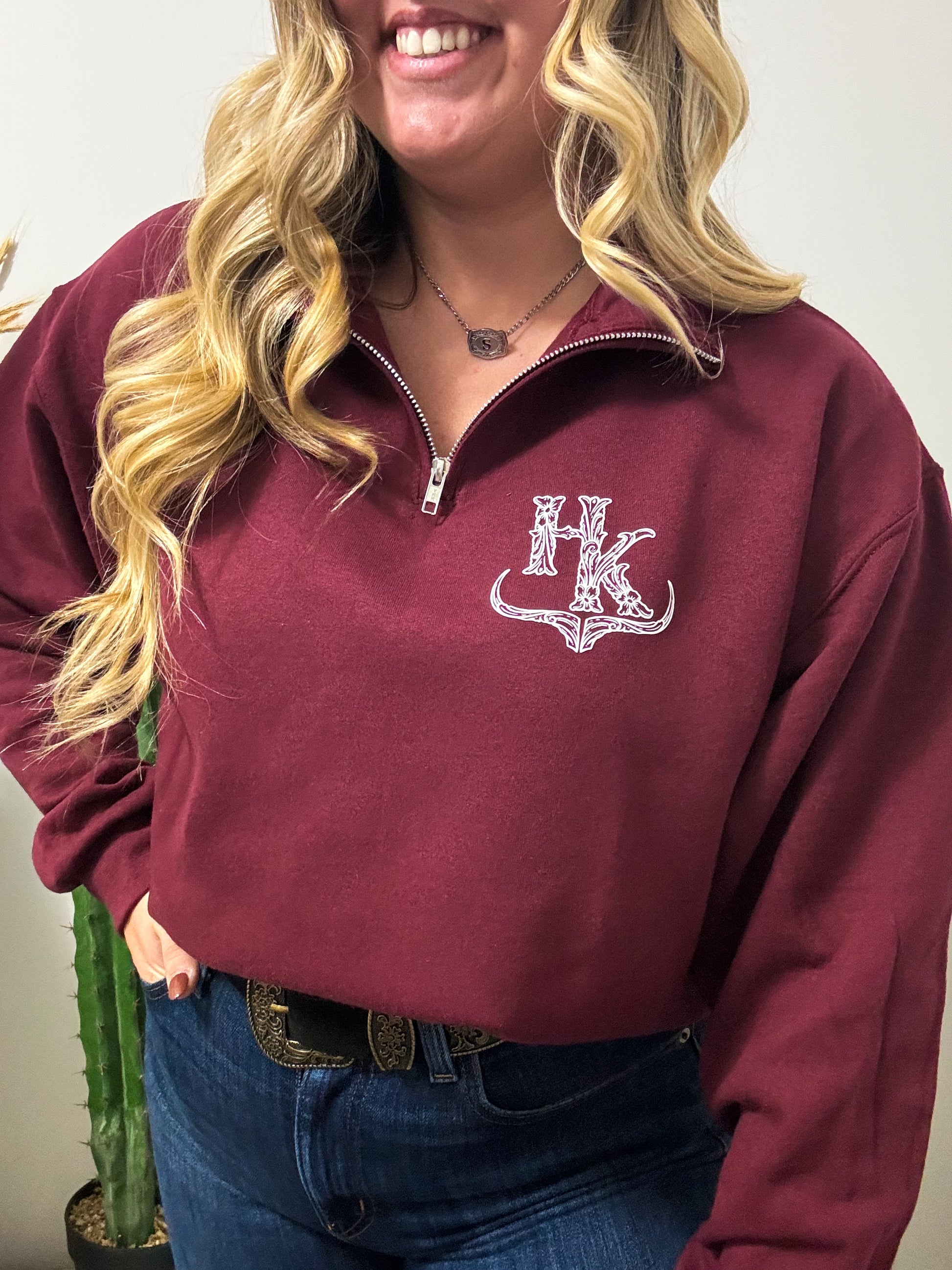 Mid view of maroon HK quarter zip pullover showing off signature western design and cozy fit.