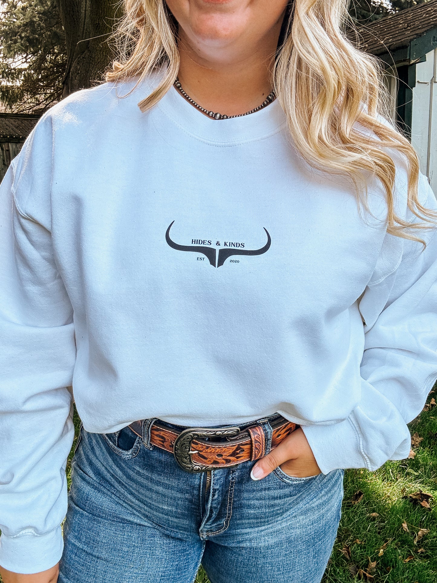 Close up of the white Original Logo Crew showing western style Hides & Kinds longhorn branding.