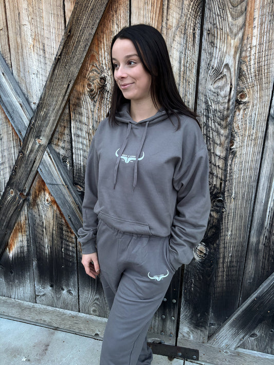 Front view of the Original Logo Matching Set in charcoal grey featuring the HK longhorn logo on the hoodie and joggers.
