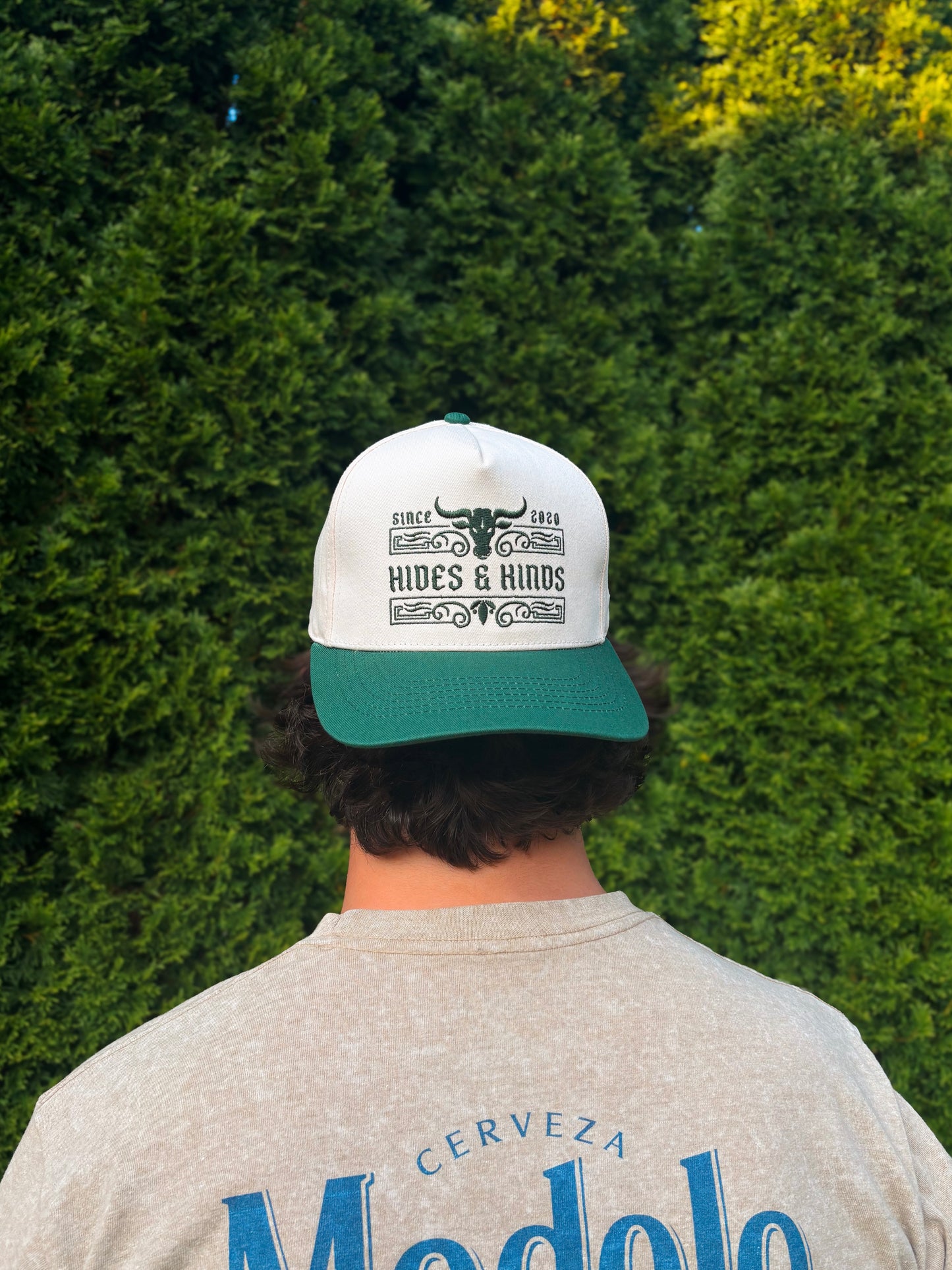 Man wearing The Ranchline Hat backwards, showing full front design from behind.