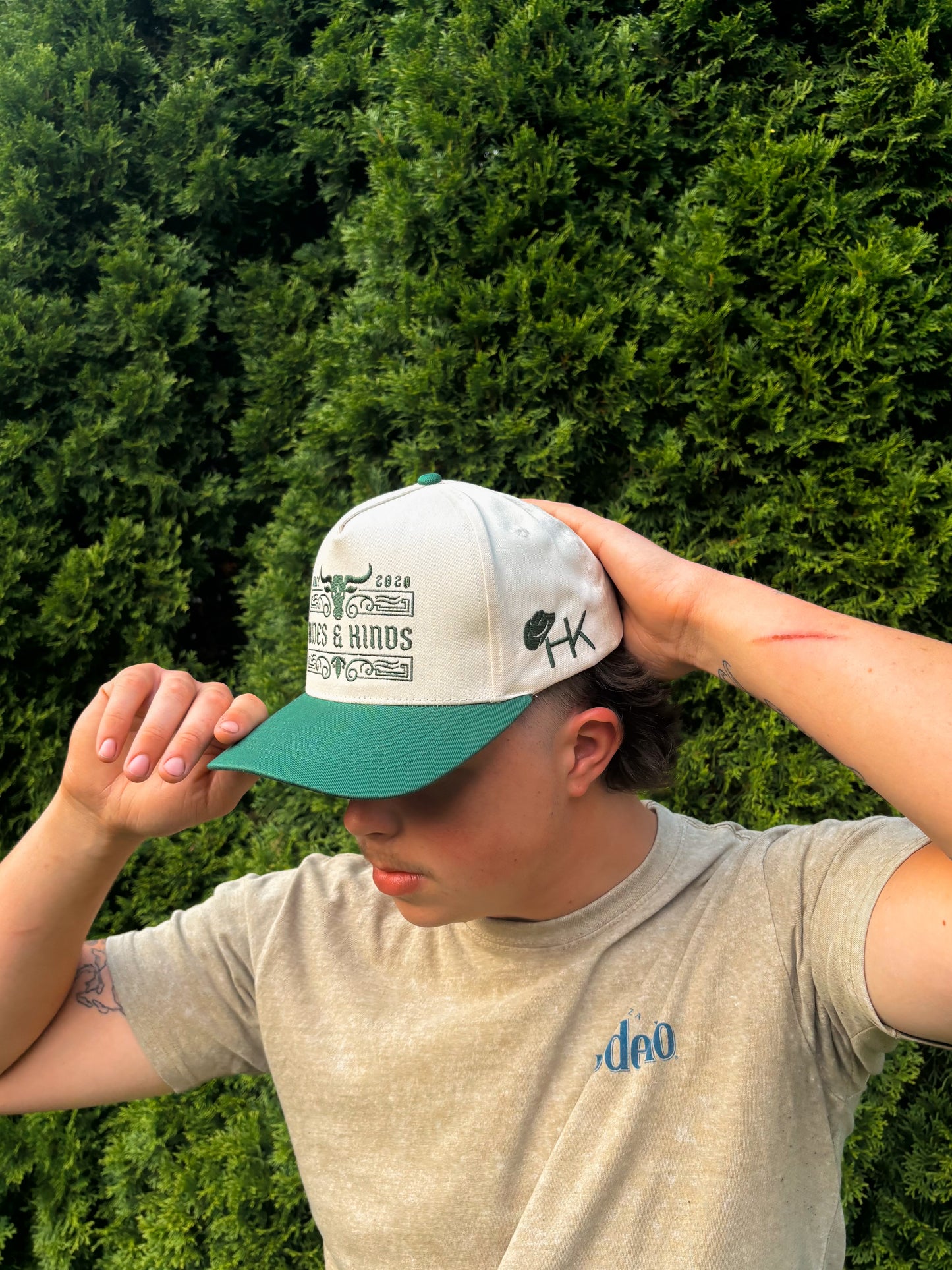 Side view of The Ranchline Hat on a man, capturing the side logo and curved brim.