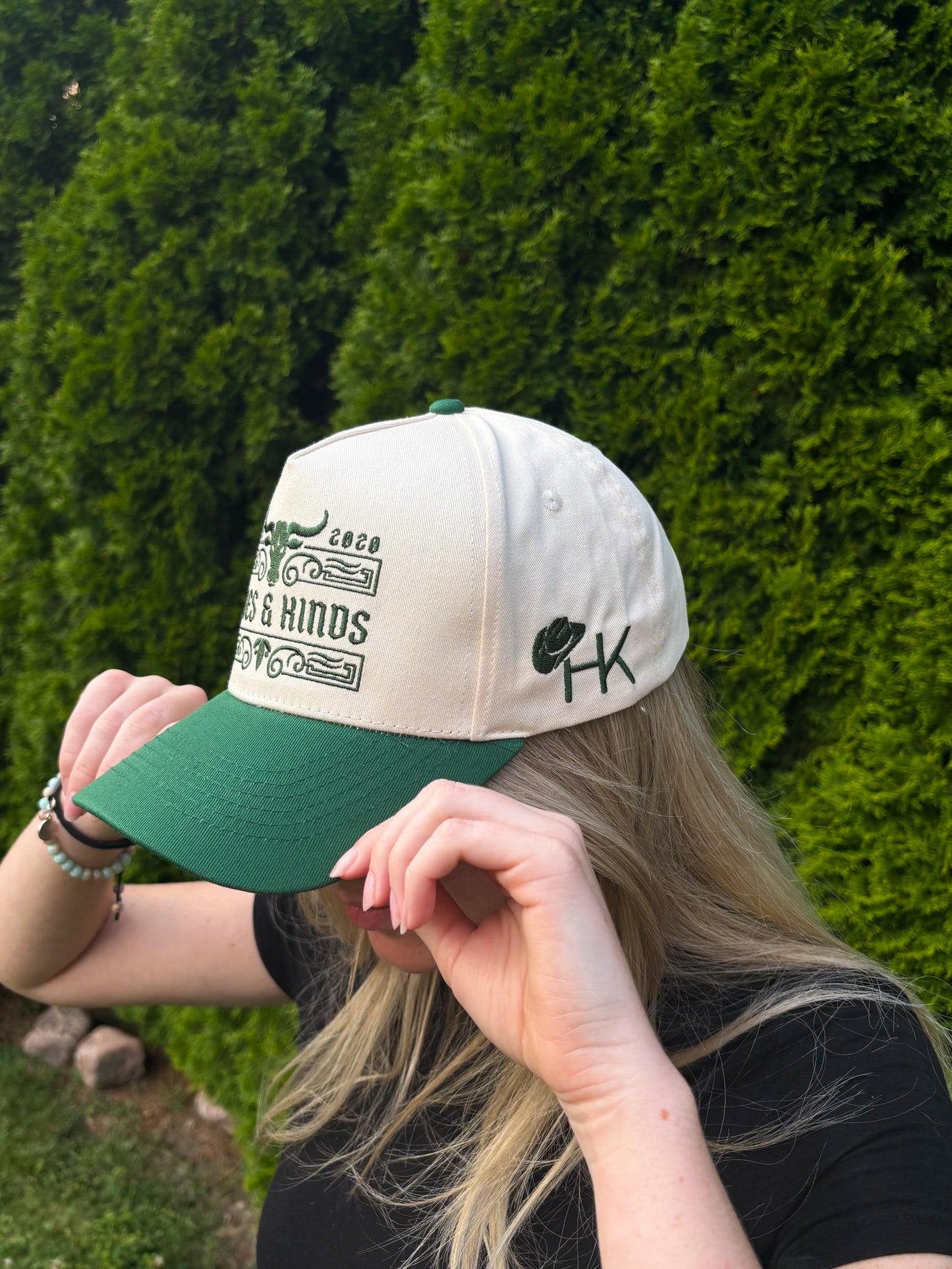 Side view of The Ranchline Hat worn by a woman, showing embroidered HK cowboy hat logo.