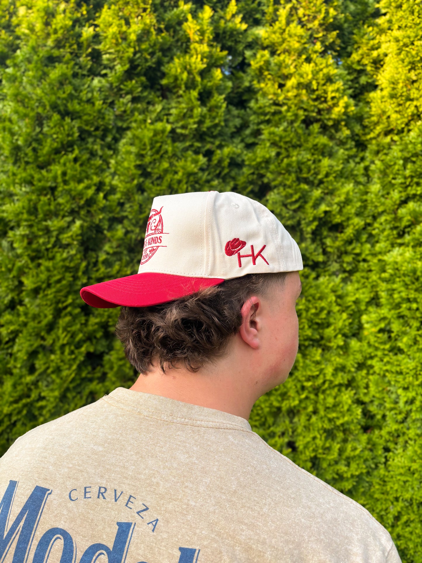 Side view of The Stampede Snapback hat showcasing HK initials and cowboy hat embroidery.