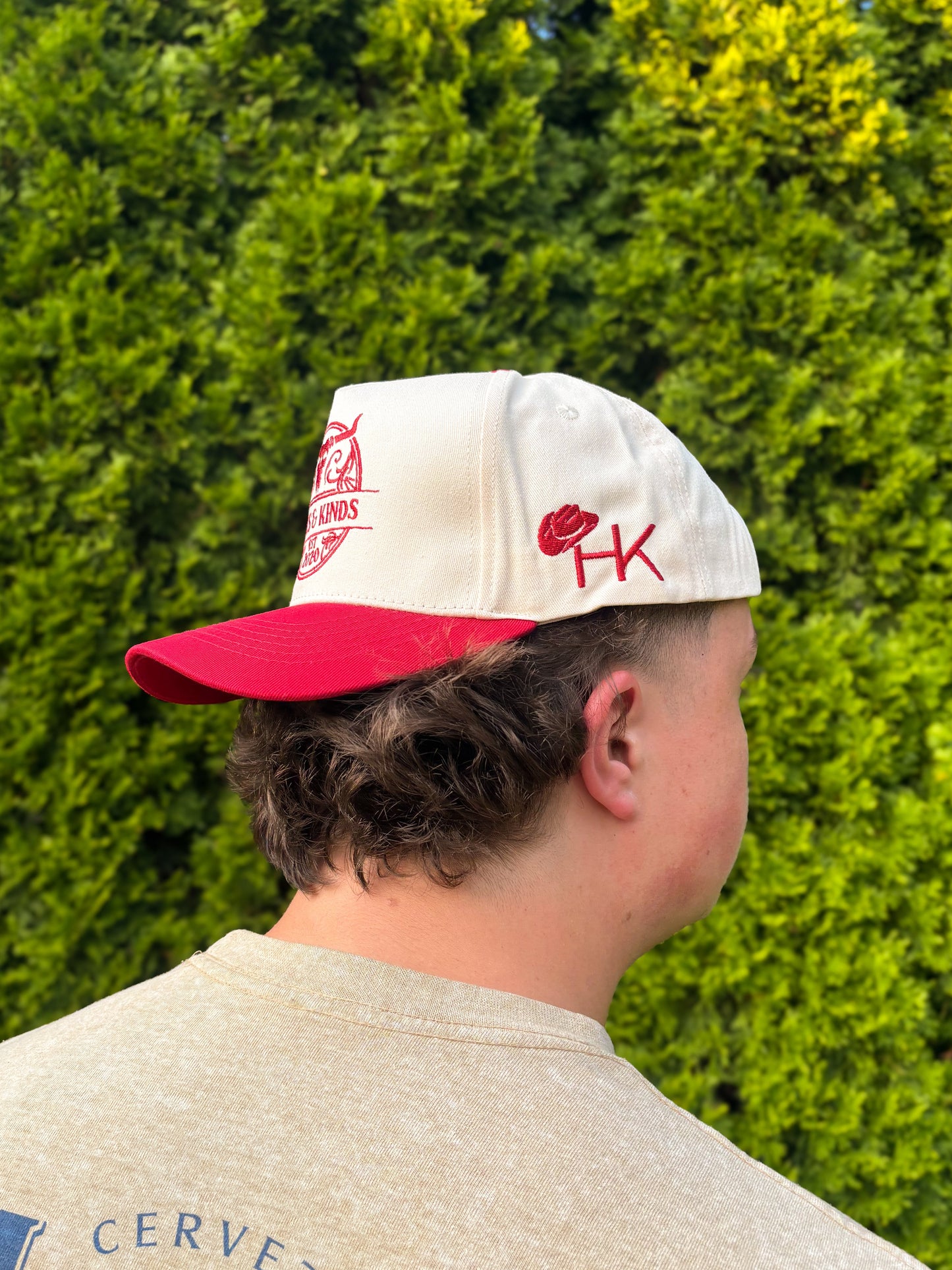 Side view of The Stampede Snapback hat showcasing HK initials and cowboy hat embroidery.