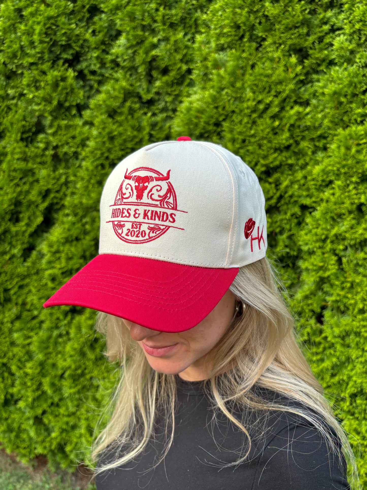 Woman wearing The Stampede Snapback hat with head tilted down, showing front embroidery.