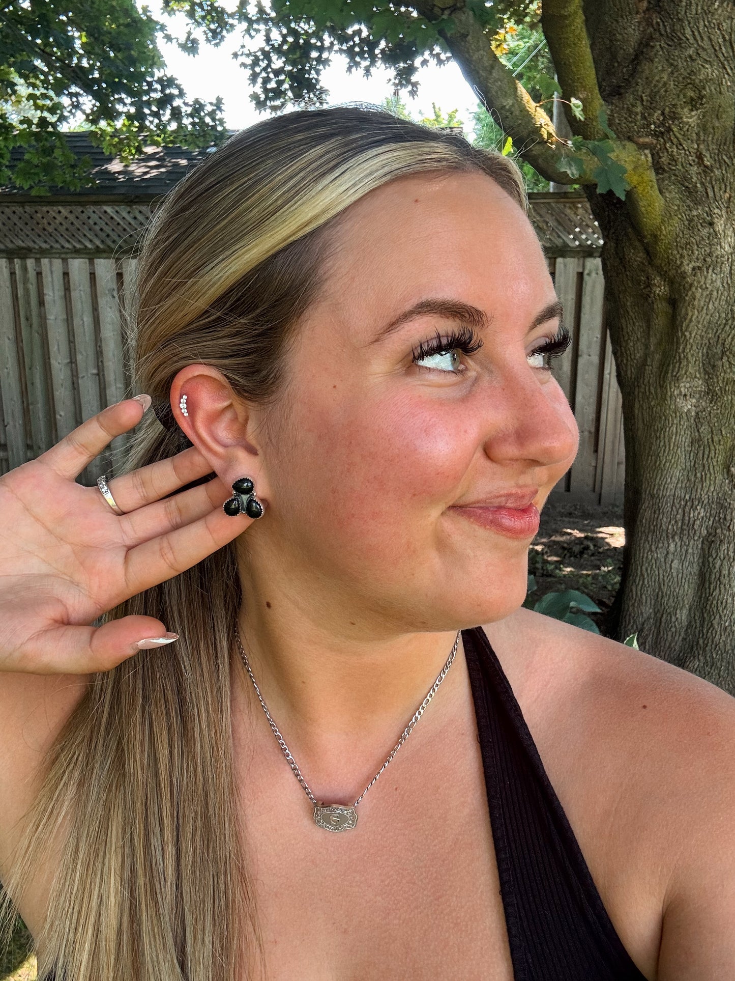 Triple Stone Stud earrings in black onyx under natural light