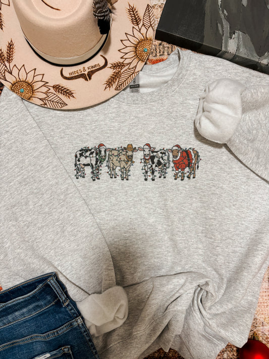 Western Christmas cow crewneck styled with embroidered hat and cozy accessories