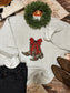 Heather grey Cowgirl Christmas sweatshirt with holiday boots graphic, styled with denim and cowhide clutch