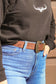 Side view of brown suede western belt with antique gold buckle