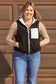 Model smiling in black fleece vest with white zipper and cozy sherpa fabric – Hides & Kinds western outerwear.