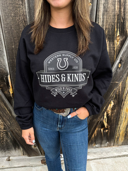 Woman wearing the Brand Outback Crewneck in black with jeans and western belt
