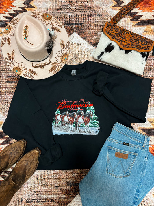 Festive western outfit featuring Budweiser Christmas crewneck, embroidered cowboy hat, leather cowhide purse, and Wrangler jeans.