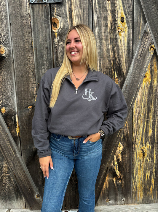 Country-inspired quarter zip in charcoal grey from Hides & Kinds worn with jeans and belt buckle