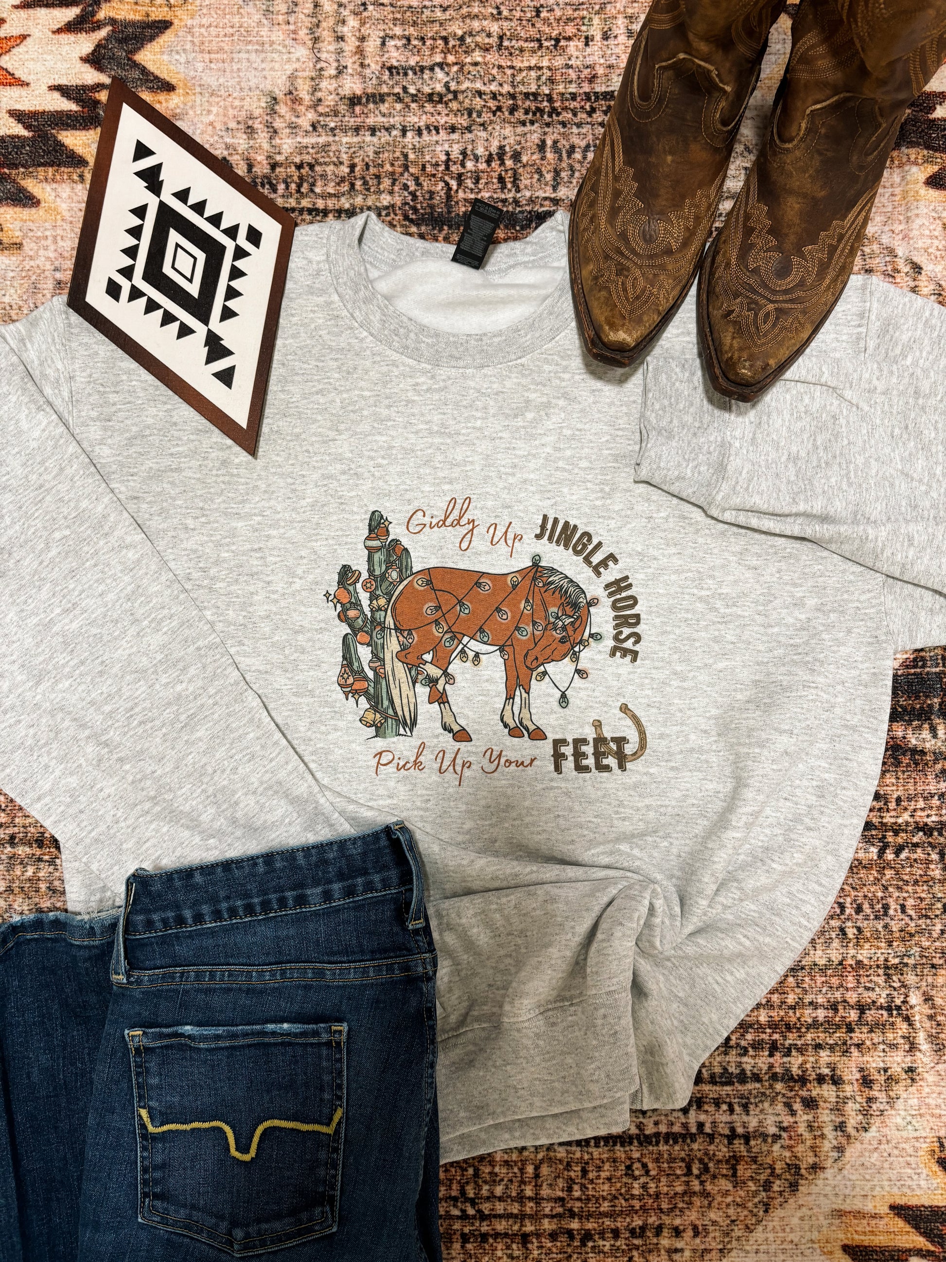 Giddy Up Jingle Horse sweatshirt by Hides and Kinds styled with dark denim and rustic western boots