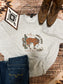 Giddy Up Jingle Horse sweatshirt by Hides and Kinds styled with dark denim and rustic western boots
