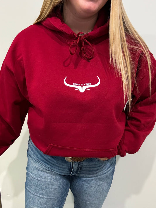 Front view of garnet red Hides & Kinds hoodie with longhorn logo