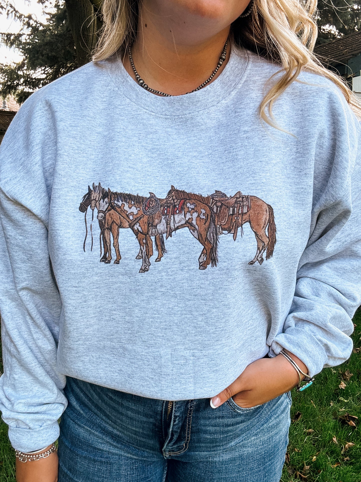Close up of three saddled horses printed on ash grey Ranch Horse Crewneck from Hides & Kinds.