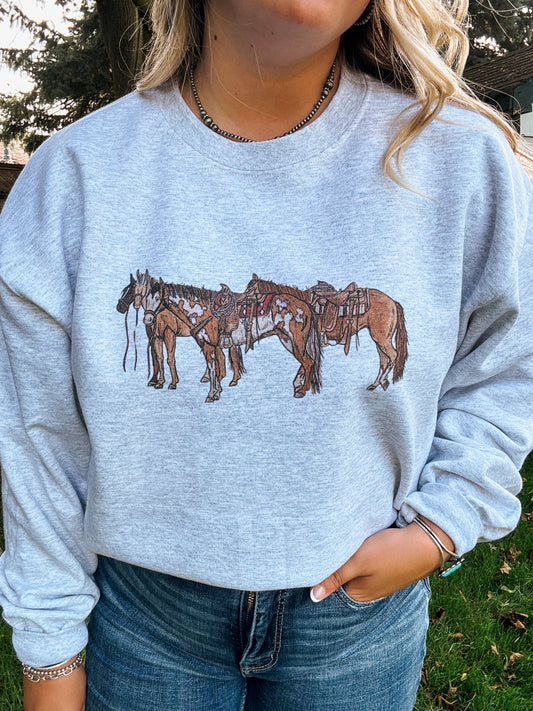 Close up of three saddled horses printed on ash grey Ranch Horse Crewneck from Hides & Kinds.