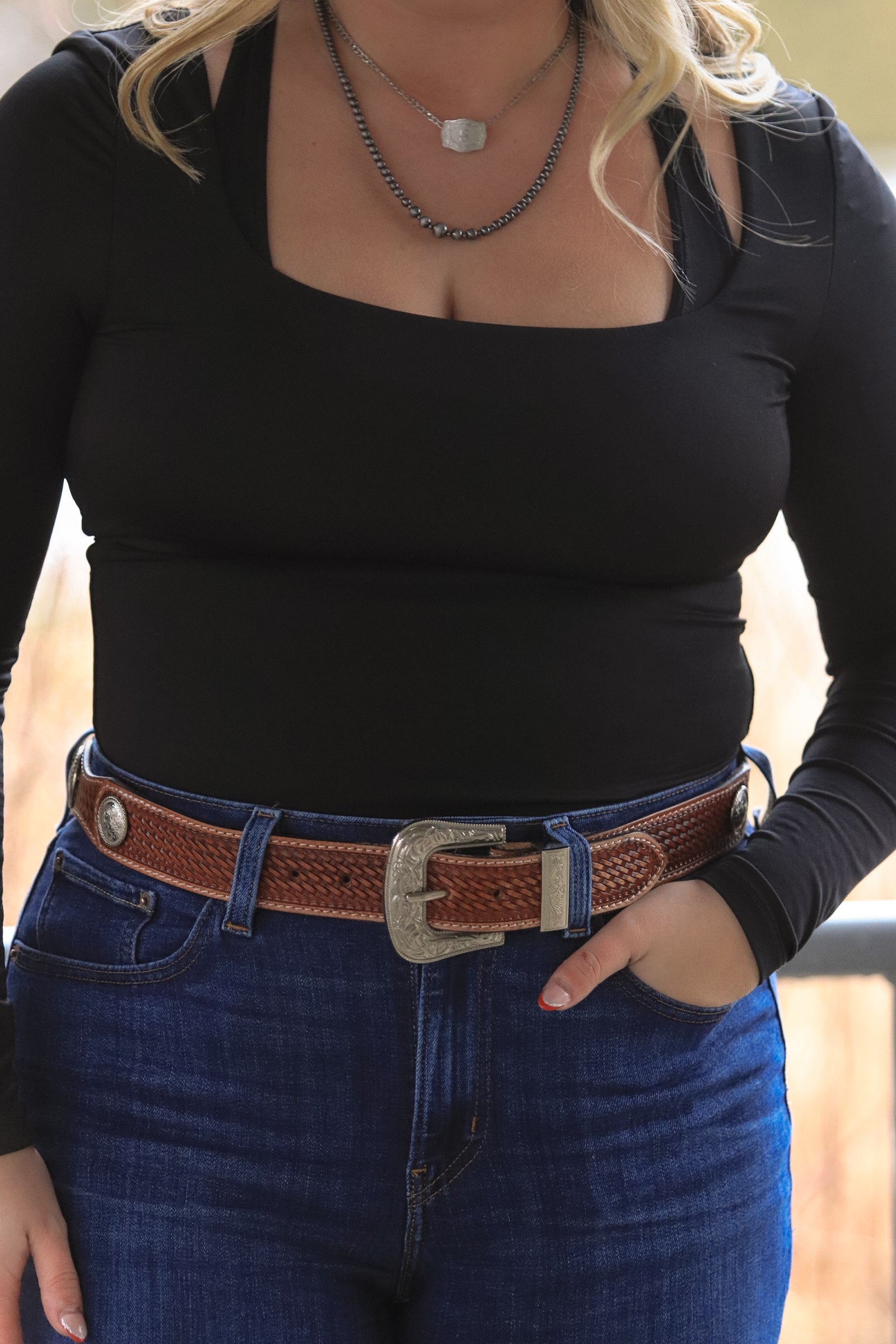 Front view of Saddle Ridge brown leather belt with silver buckle
