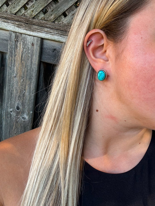 Side view of genuine Kingman turquoise stud earrings with western flair