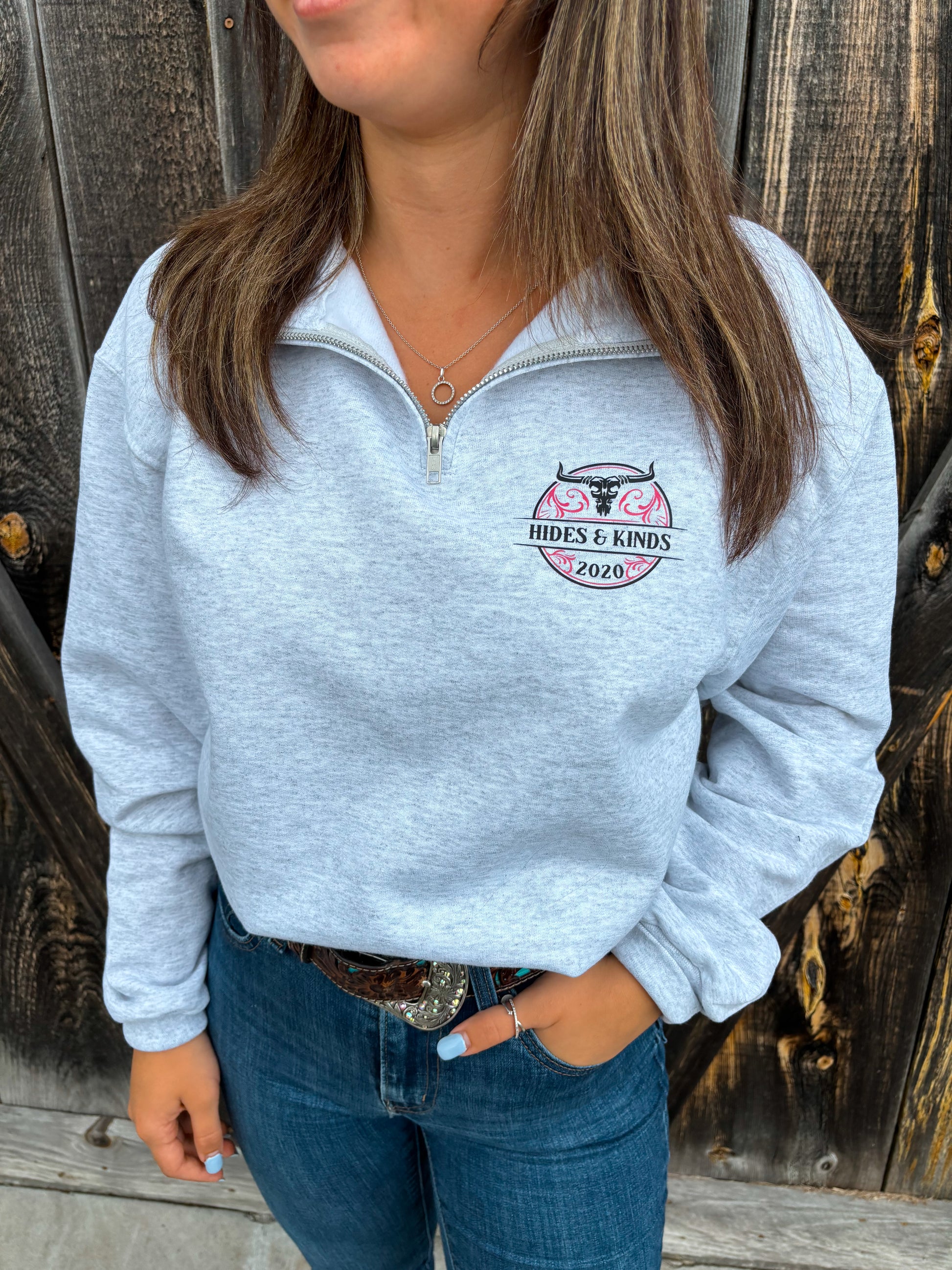 Woman wearing the Stampede Quarter Zip in pink by Hides & Kinds, front view