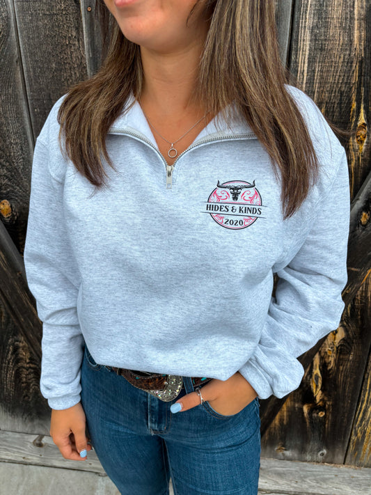 Woman wearing the Stampede Quarter Zip in pink by Hides & Kinds, front view