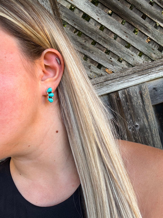 Close up of woman wearing turquoise Stone Row Studs with triple stone vertical design