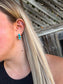 Close up of woman wearing turquoise Stone Row Studs with triple stone vertical design