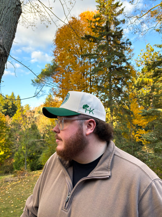 Side profile of Hides & Kinds Country Line Hat in green and cream featuring embroidered HK logo.
