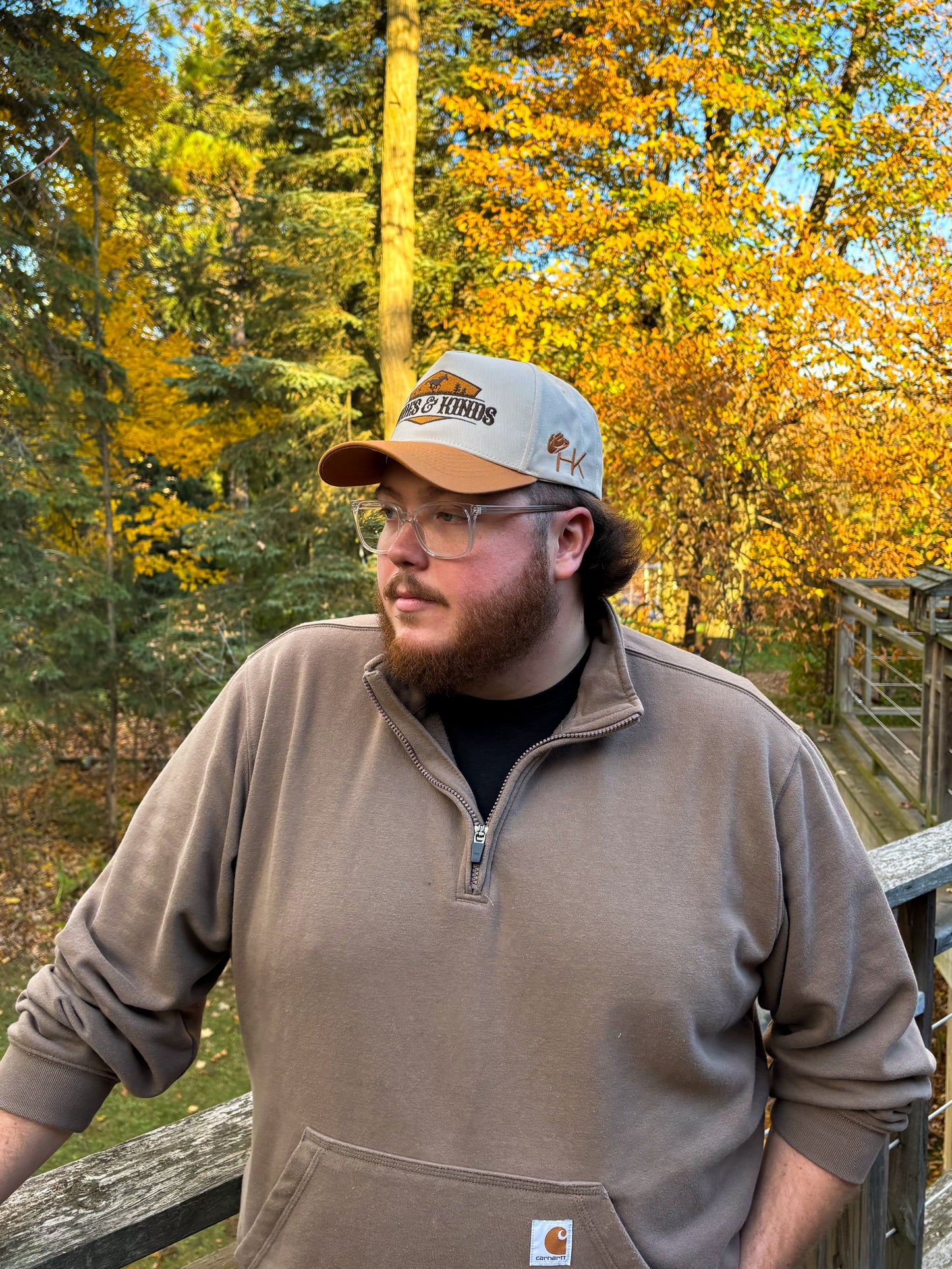 Side profile of tan and cream Hides & Kinds Houston Hat with embroidered HK logo on the side panel.