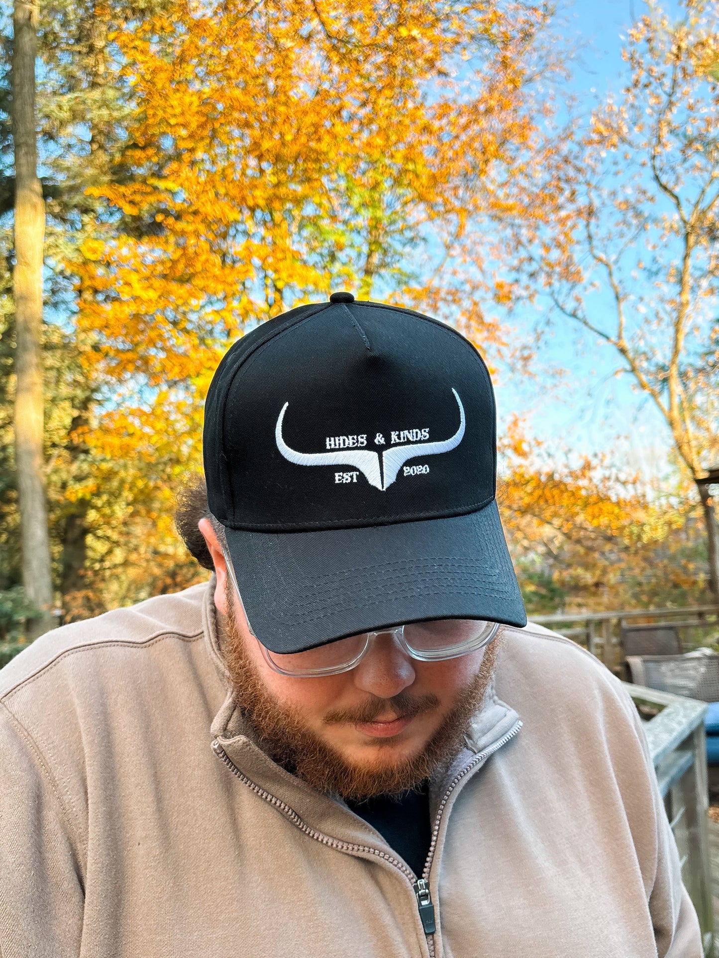 Front view of Hides & Kinds Original Logo Hat in black and white featuring embroidered longhorn logo and EST 2020 text.