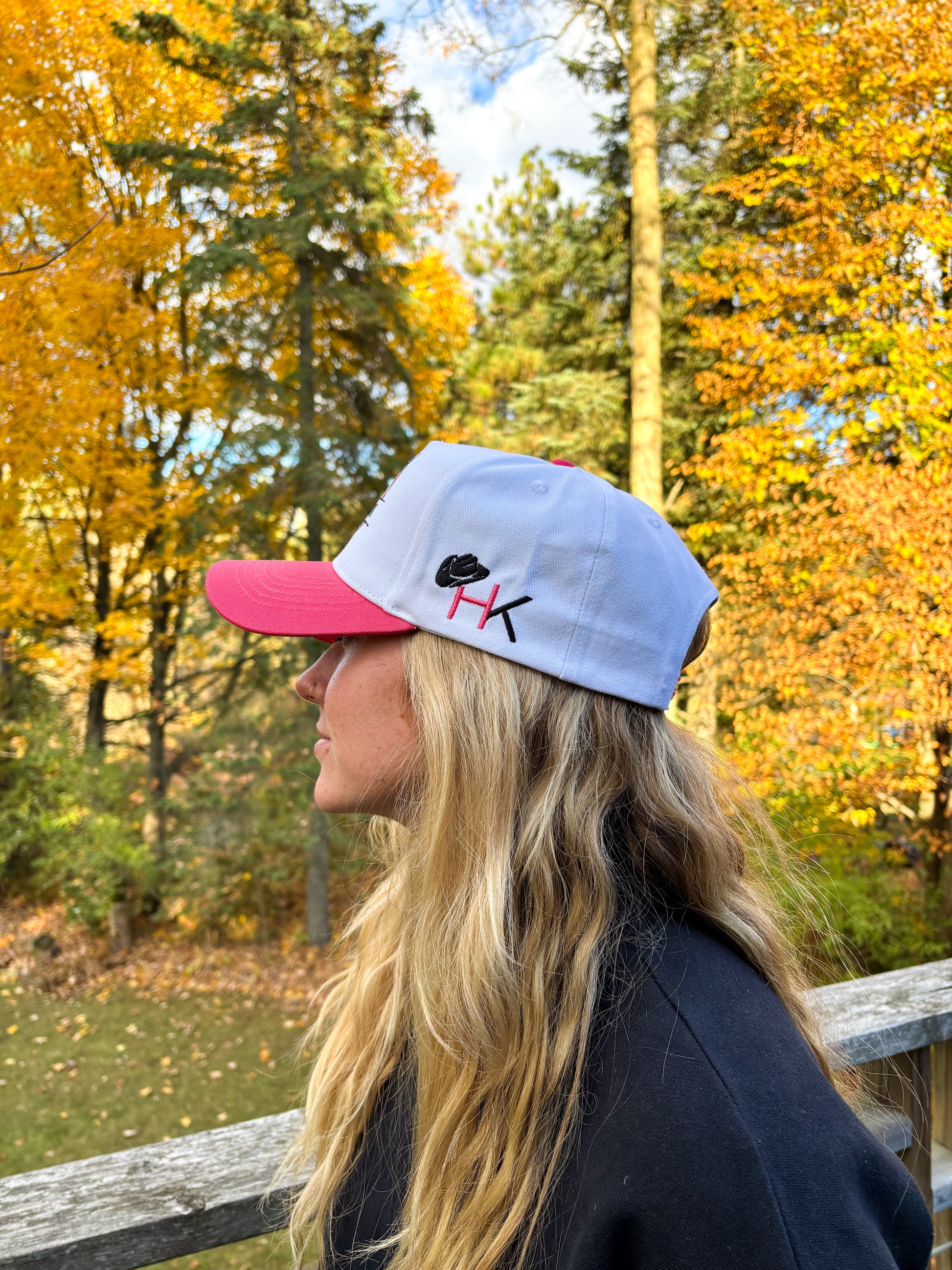 Back view of The Stampede Snapback in pink and white with Wild N Free embroidery above snapback closure.