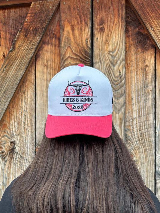 Front view of The Stampede Snapback by Hides & Kinds in pink and white with embroidered Wild N Free longhorn logo.