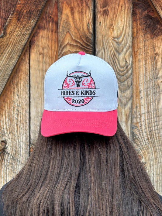 Front view of The Stampede Snapback by Hides & Kinds in pink and white with embroidered Wild N Free longhorn logo.