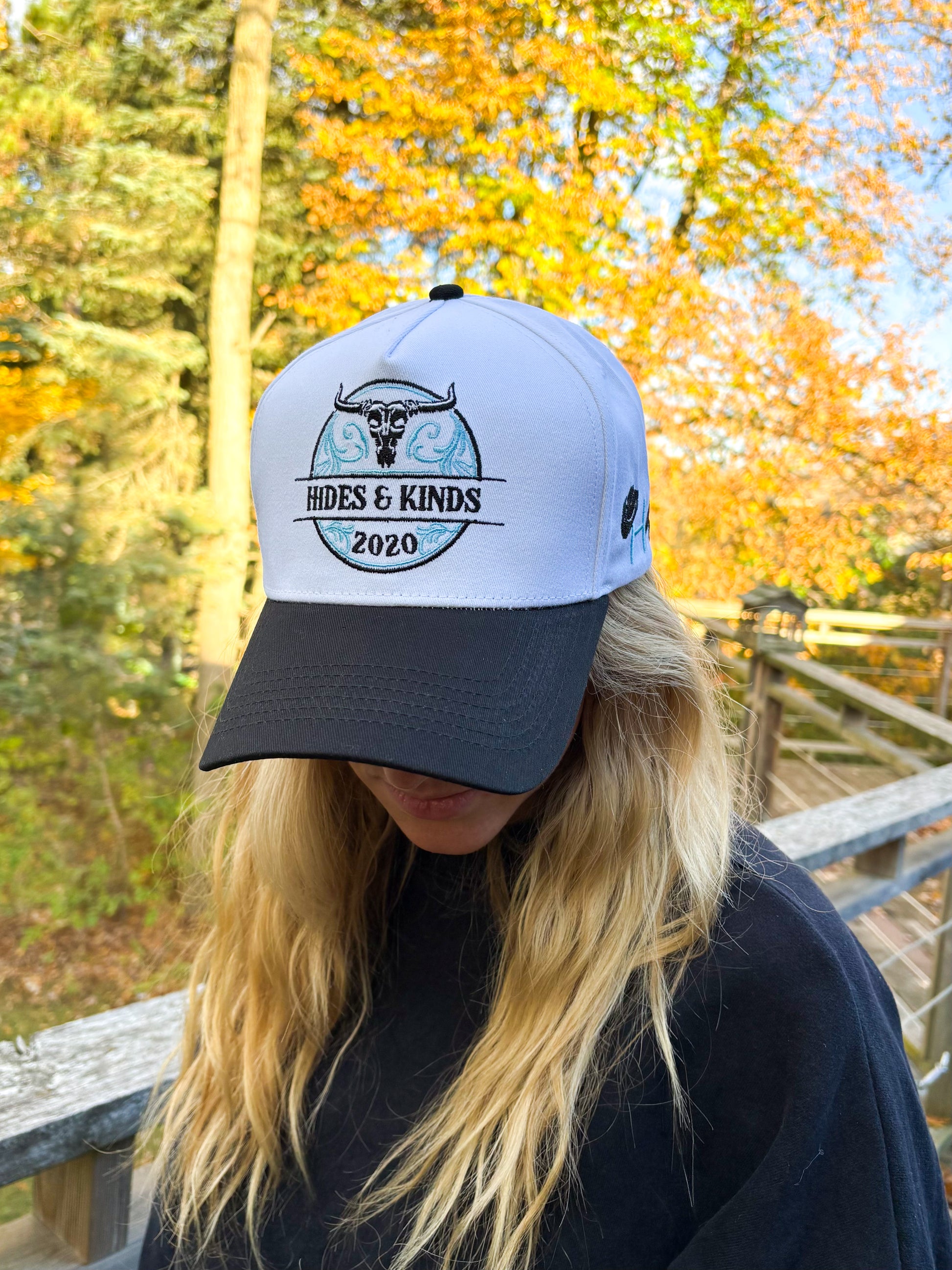 Front view of Hides & Kinds Stampede Snapback in teal and black with embroidered bull skull logo.