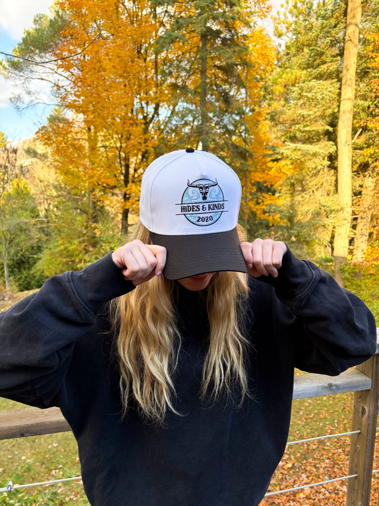 Side profile of teal and black Hides & Kinds Stampede Snapback featuring embroidered HK logo on the side.