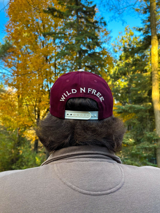 Back view of maroon and natural Hides & Kinds Wild N Free Hat featuring Wild N Free embroidery above the snapback.