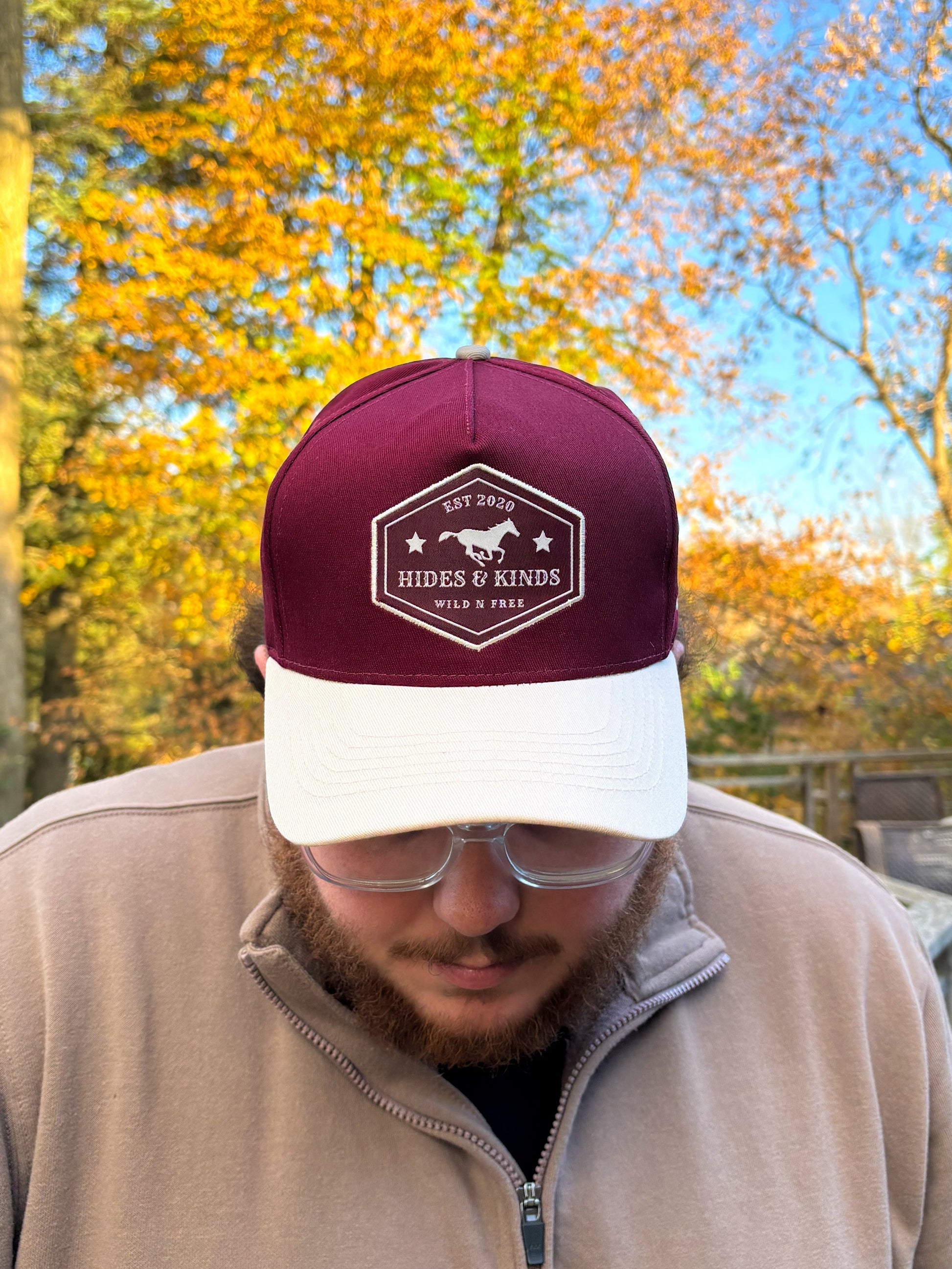 Close up of maroon and natural Hides & Kinds Wild N Free Hat showing detailed stitching and patch.