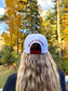 Back view of red and white Hides & Kinds Wild N Free Hat with embroidered Wild N Free lettering above the snapback closure.