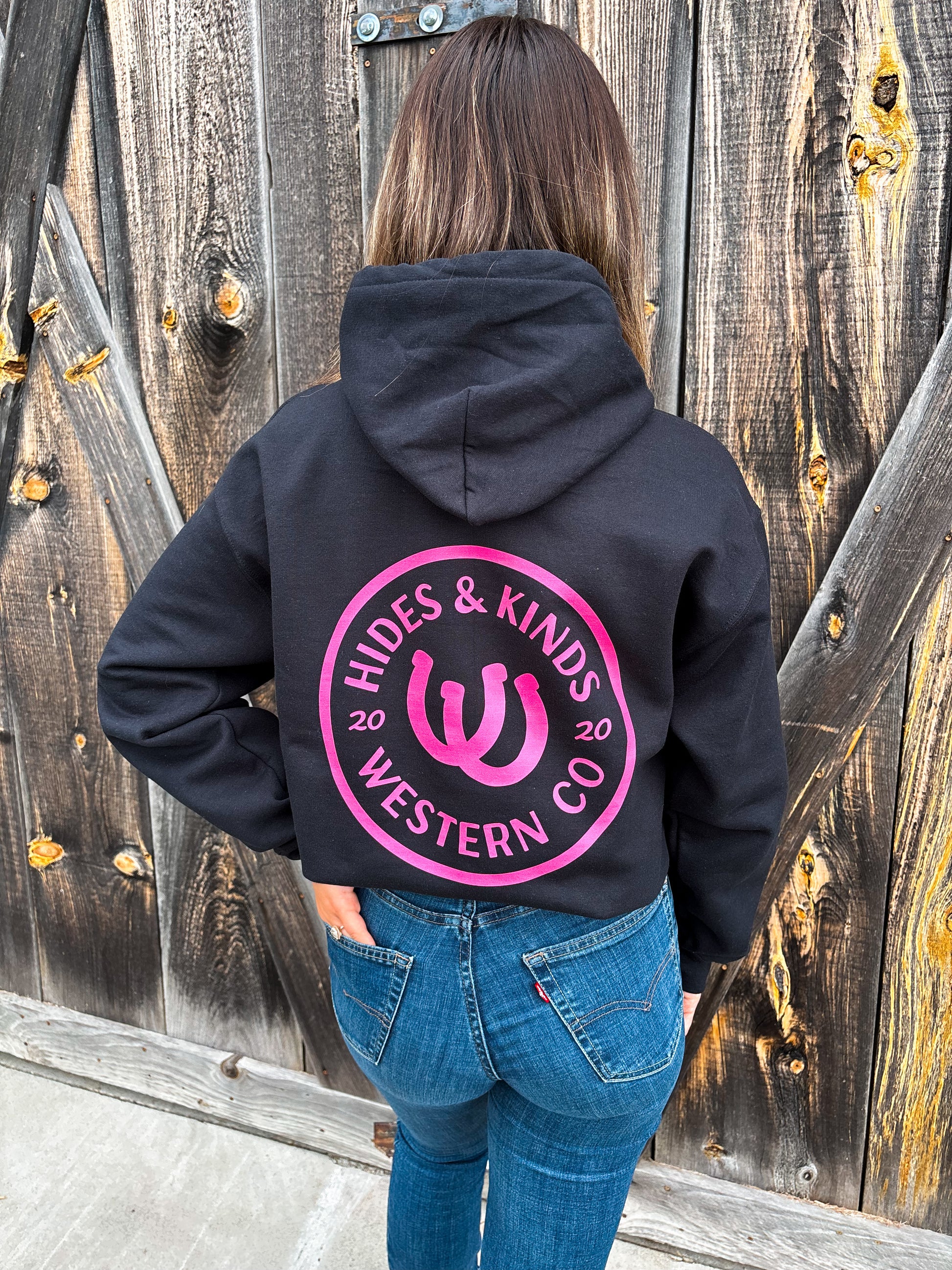 Back view of Outrider Hoodie in black with bold pink H&K horseshoe logo