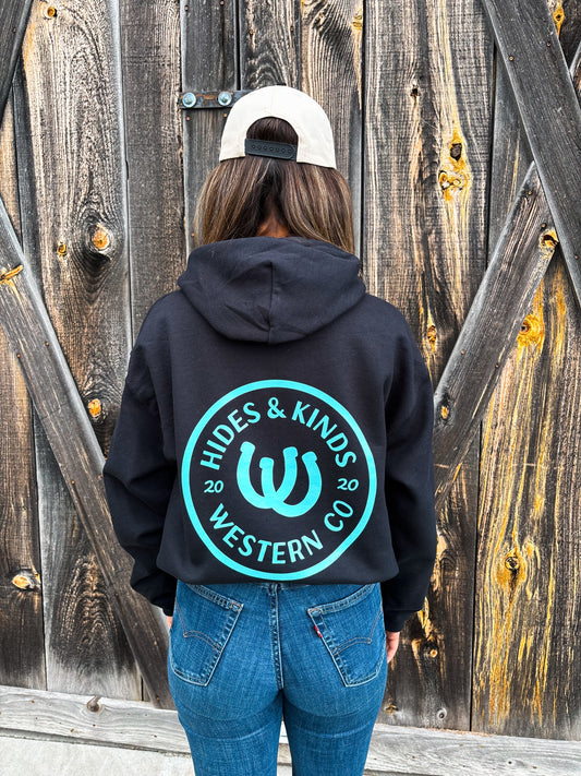 Back view of Outrider Hoodie in black with turquoise horseshoe logo – Hides & Kinds