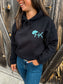 Front close-up of Outrider Hoodie featuring HK cowboy hat logo in turquoise